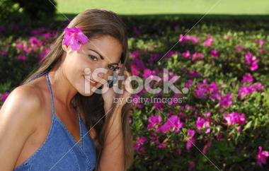stock-photo-2864045-girl-talking-on-cell-phone-by-flower-bed