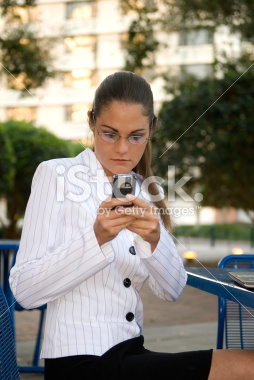 stock-photo-3561176-business-woman-working-on-her-cell-phone