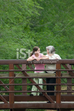 stock-photo-3719328-grandmother-and-grand-daughter-talking-on-bridge