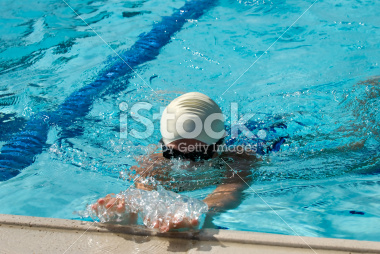 Swimmer finishing a race at a swim meet