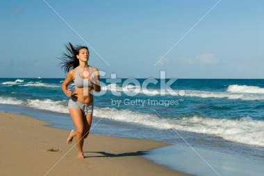 stock-photo-5645823-young-woman-jogging-on-the-beach